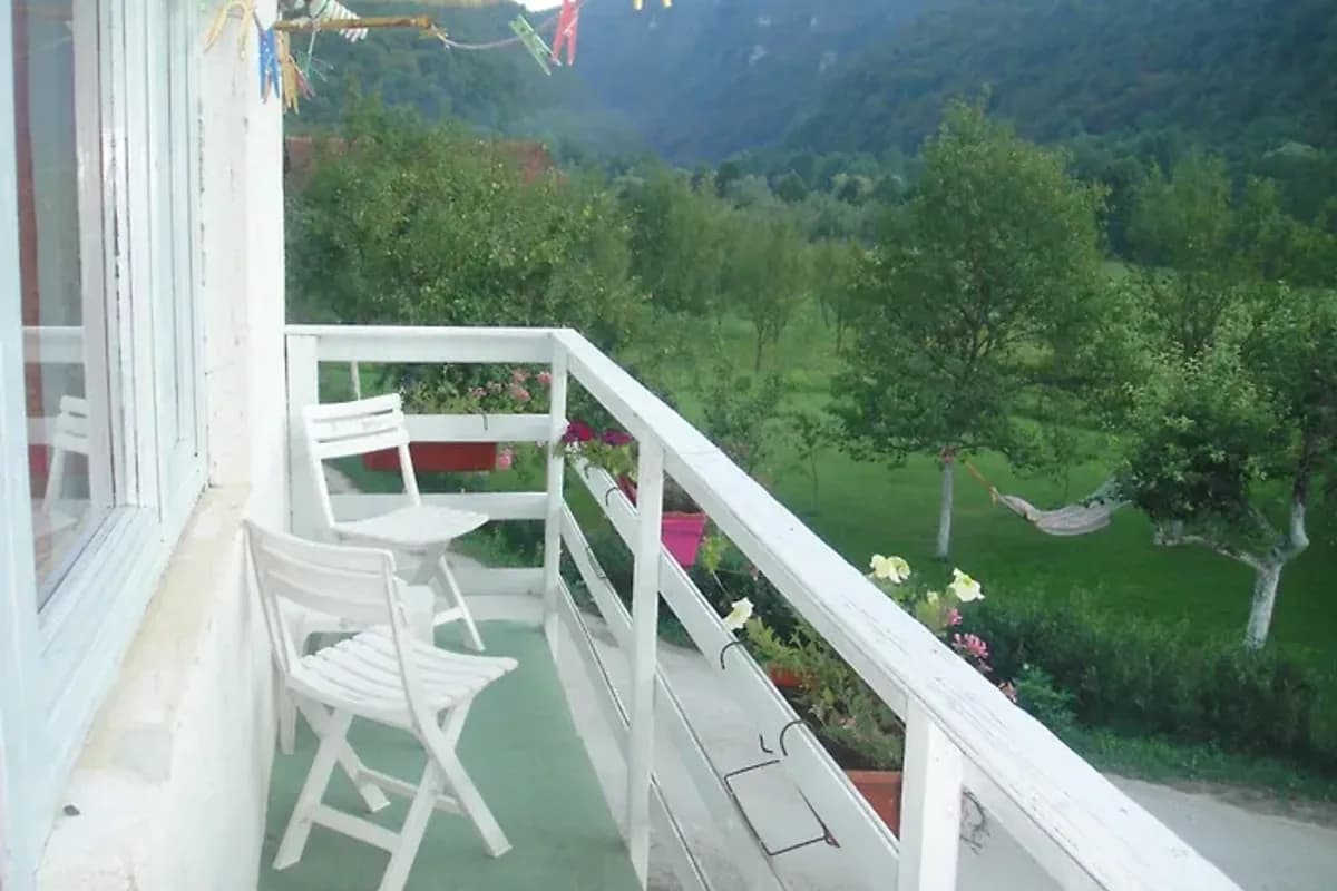 Home-Vasva and Hazim holiday apartment balcony with white chairs overlooking the valley near Ćukovi