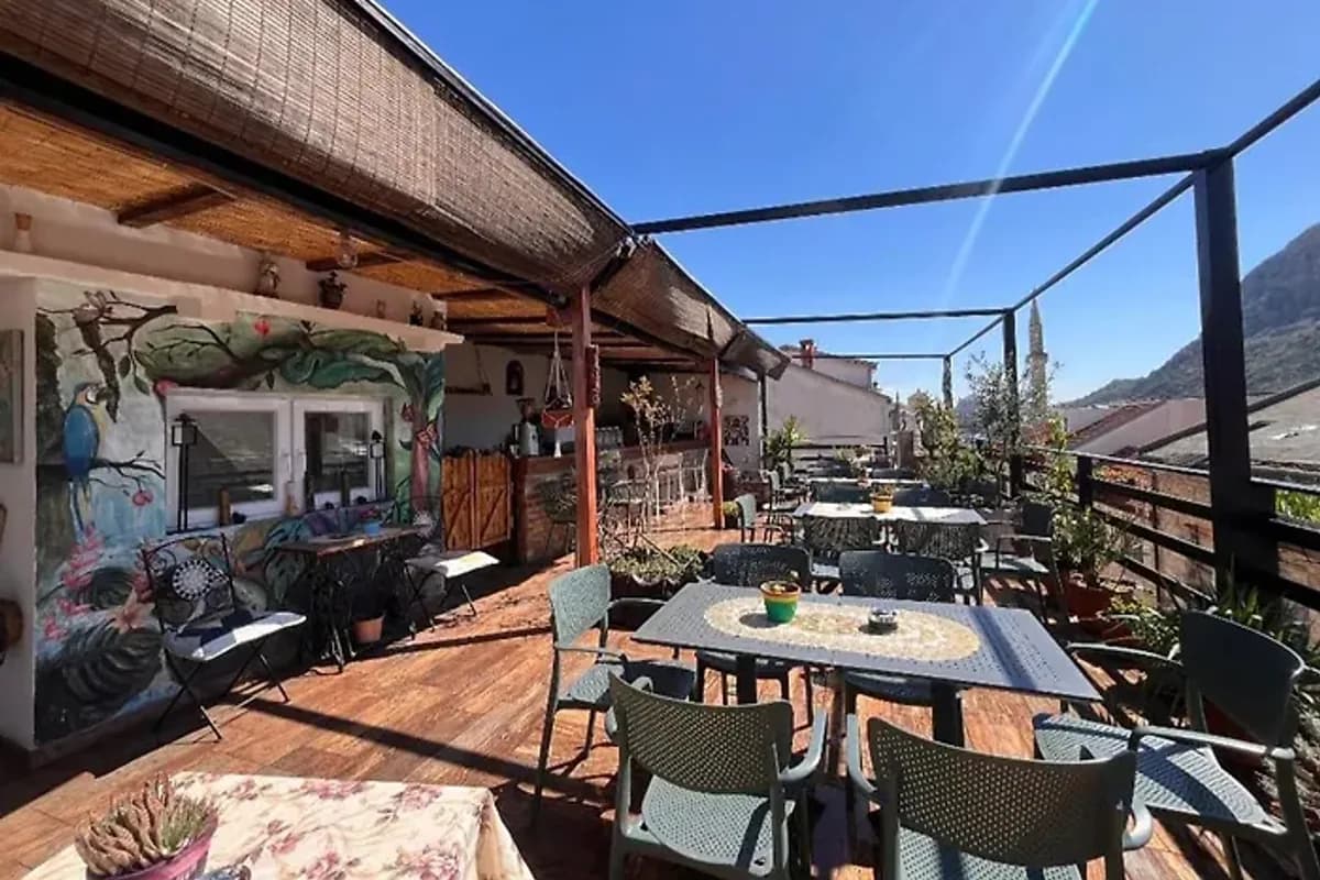 Hostel Backpackers Mostar shared rooftop terrace with outdoor dining tables and seating