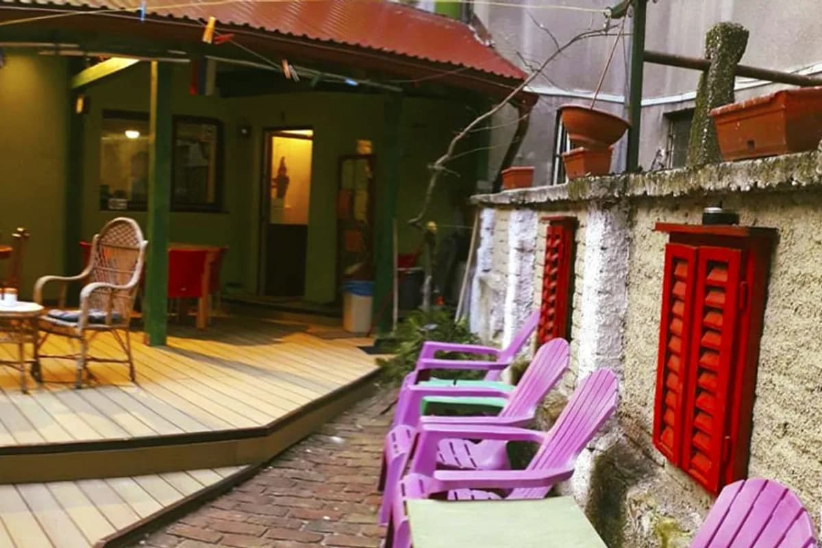 Covered common courtyard and colorful seating at Hostel Balkan Han in Sarajevo