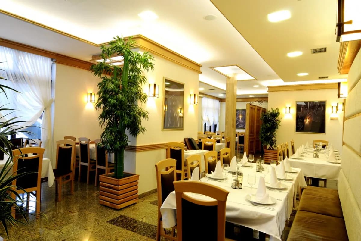 Dining room and set tables at Hotel Vila Vrbas in Banja Luka