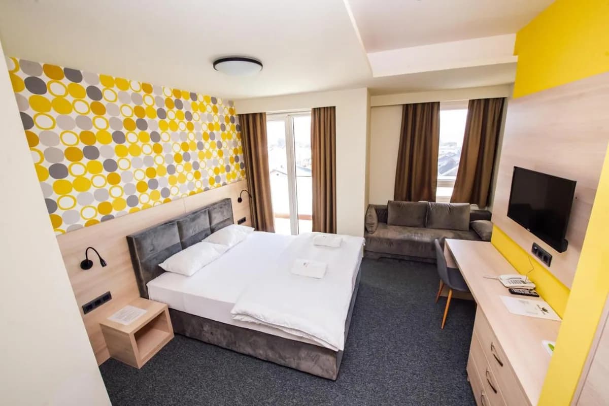 Yellow and white double guest bedroom at Hotel Zlatna Kruna in Banja Luka