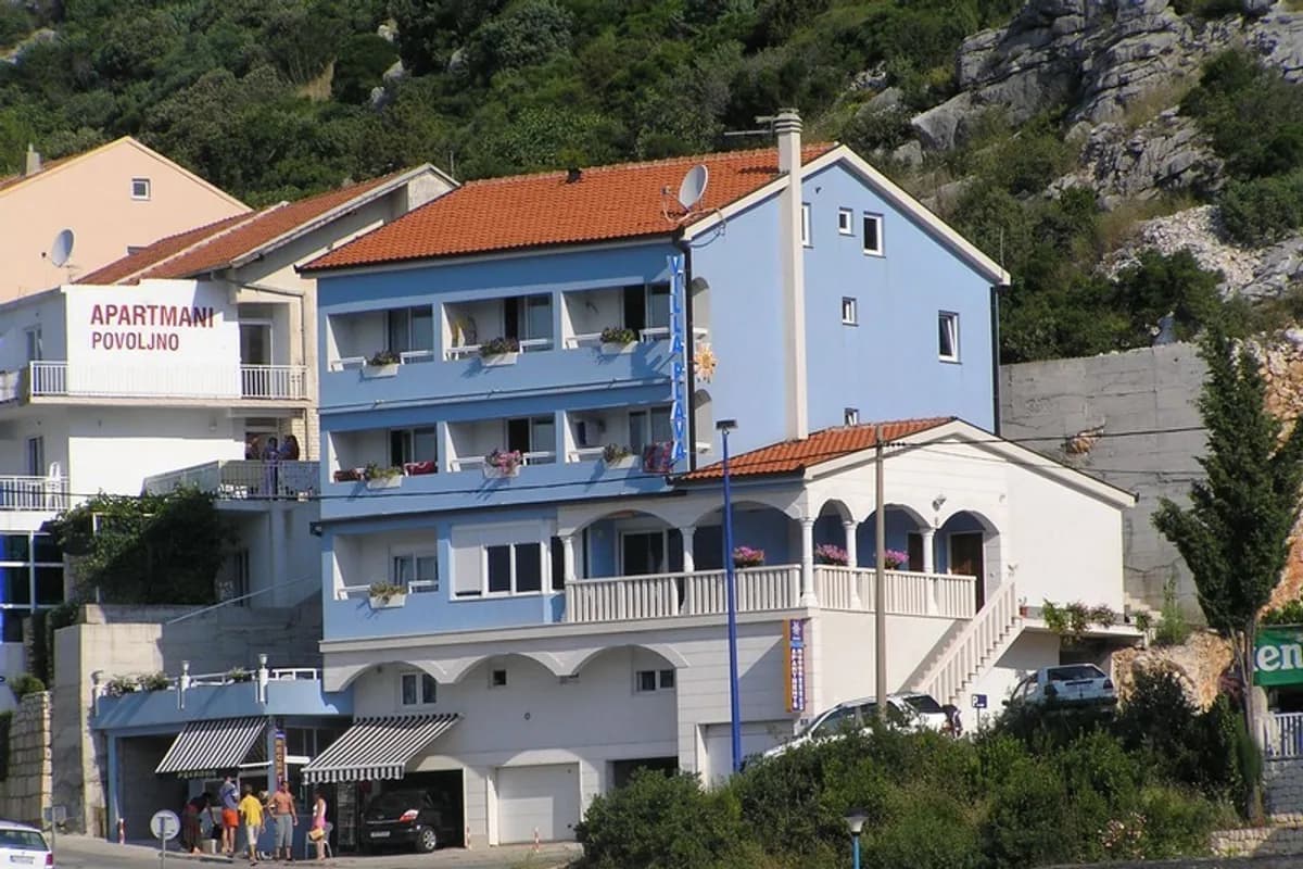 Blue-and-white seaside Villa Plava apartment building with balconies in Neum